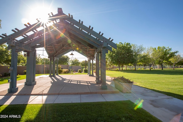 view of property's community featuring a patio area, a pergola, a gazebo, and a lawn