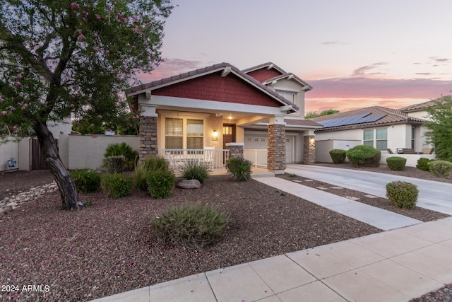 craftsman house with solar panels and a garage