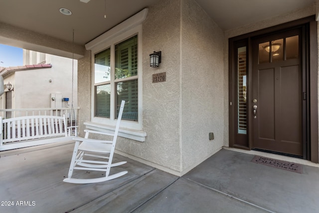 view of exterior entry with covered porch