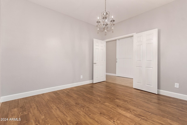 interior space featuring hardwood / wood-style floors and a notable chandelier