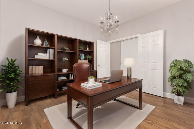 office area with a chandelier and hardwood / wood-style flooring