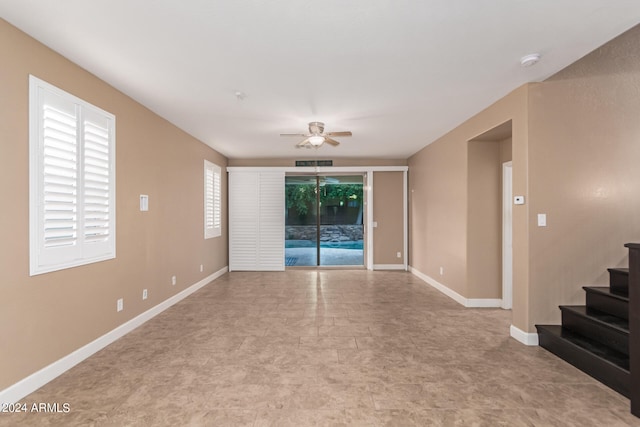 spare room with light tile patterned flooring, ceiling fan, and a healthy amount of sunlight