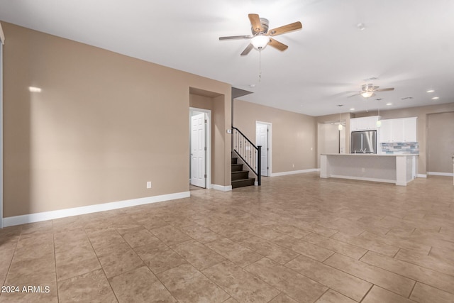 unfurnished living room featuring ceiling fan and light tile patterned floors