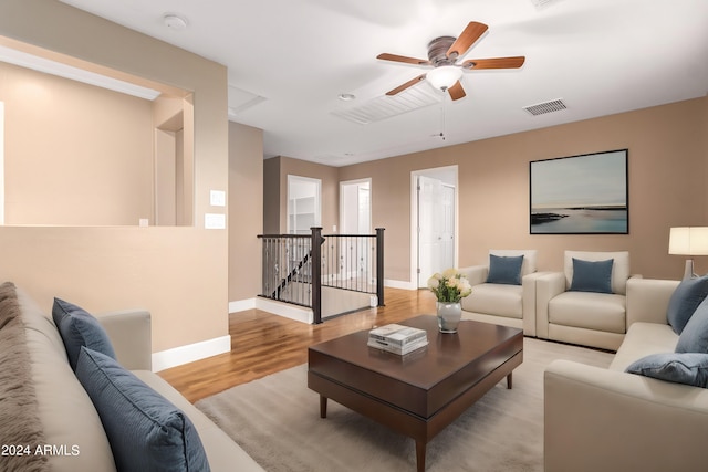 living room with ceiling fan and light hardwood / wood-style flooring