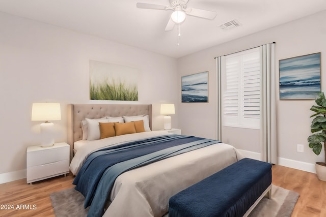 bedroom with ceiling fan and light hardwood / wood-style floors