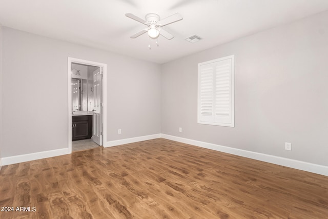 unfurnished room with ceiling fan and wood-type flooring