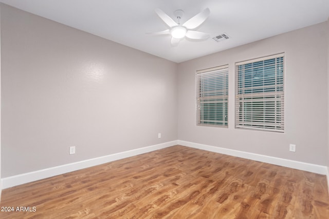 empty room with hardwood / wood-style flooring and ceiling fan