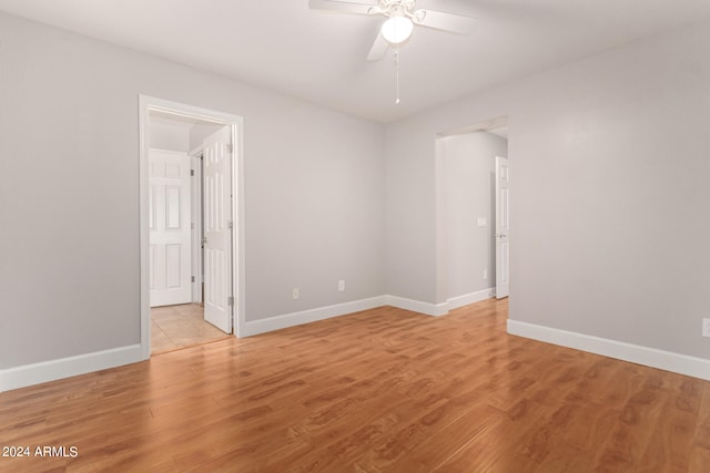 unfurnished room with light wood-type flooring and ceiling fan