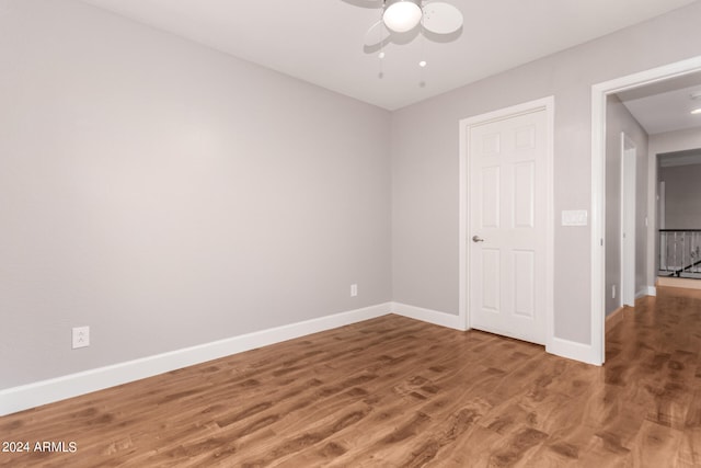 unfurnished bedroom featuring hardwood / wood-style floors and ceiling fan