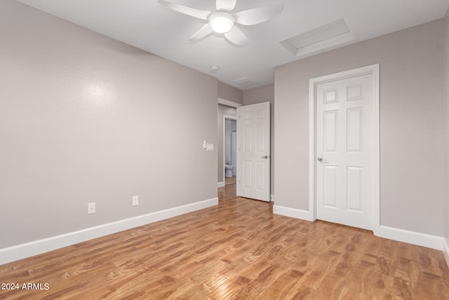 unfurnished bedroom with ceiling fan and light wood-type flooring