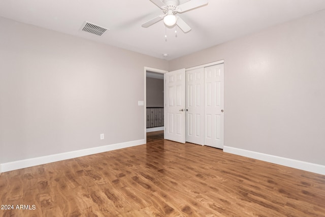 unfurnished bedroom with a closet, ceiling fan, and hardwood / wood-style floors