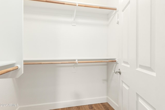 walk in closet with hardwood / wood-style floors