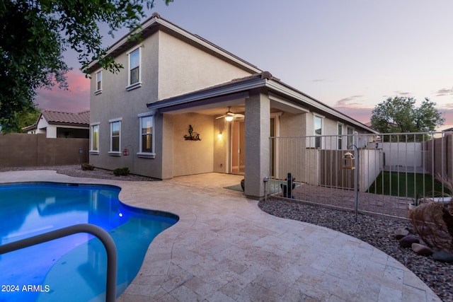 pool at dusk with a patio