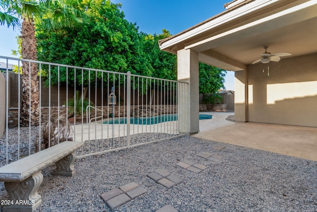 exterior space with a fenced in pool, ceiling fan, and a patio area