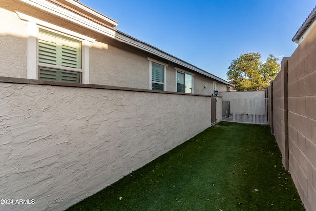 view of side of property with a lawn