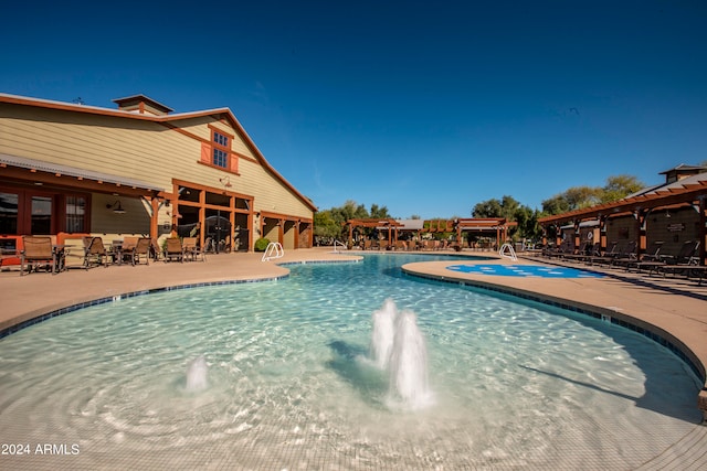 view of pool featuring pool water feature and a patio area