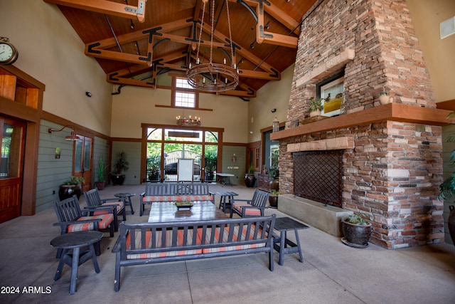 view of patio / terrace with ceiling fan and an outdoor living space with a fireplace