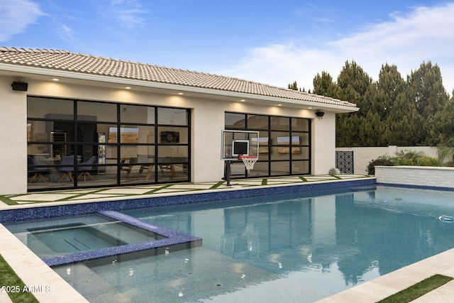 view of swimming pool with an in ground hot tub