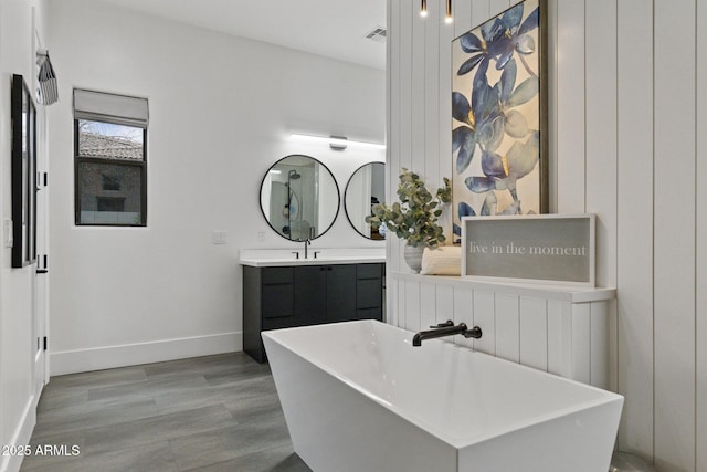 bathroom featuring vanity, hardwood / wood-style floors, and a washtub