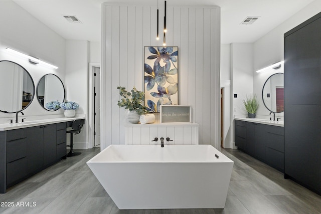 bathroom with hardwood / wood-style flooring, vanity, and a bathtub