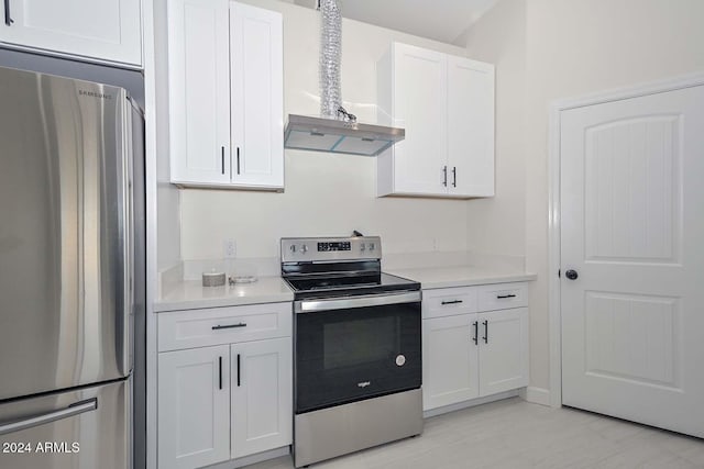 kitchen featuring white cabinets, appliances with stainless steel finishes, and wall chimney range hood