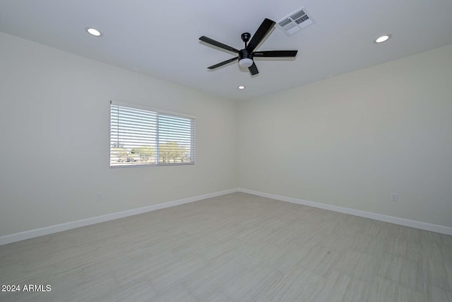 spare room with ceiling fan and light hardwood / wood-style floors