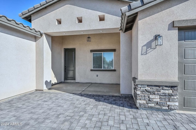 property entrance featuring a patio