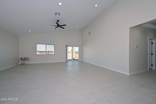 unfurnished room with high vaulted ceiling and ceiling fan