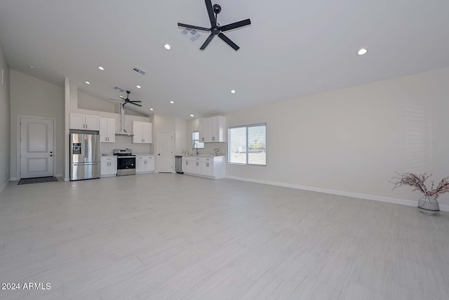 unfurnished living room with ceiling fan, sink, and high vaulted ceiling