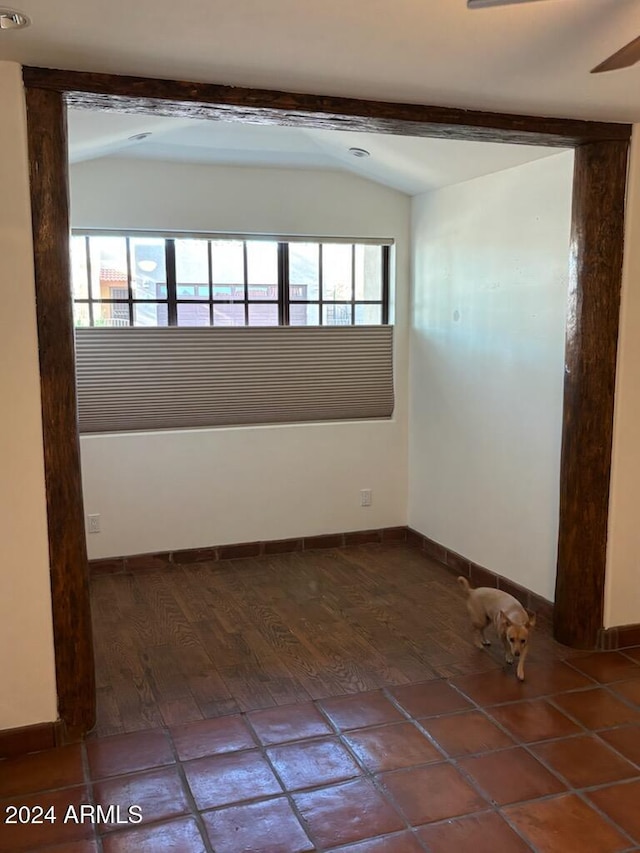 spare room with lofted ceiling and a healthy amount of sunlight