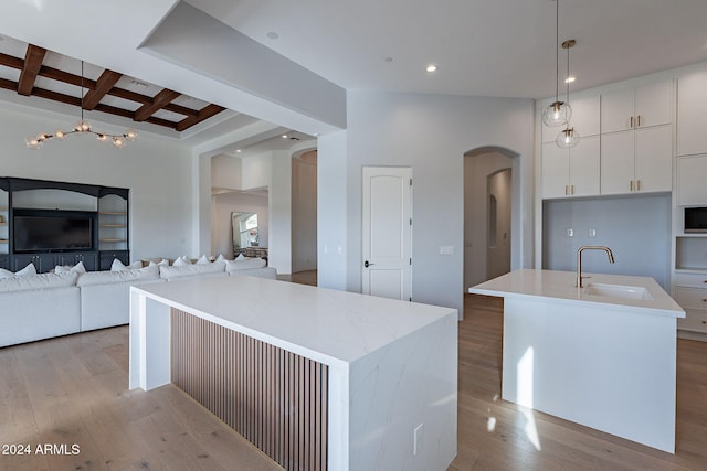11328 E Dreyfus Ave, Scottsdale, AZ 85259 - kitchen with a center island with sink, arched walkways, light wood-style floors, recessed lighting, and coffered ceiling