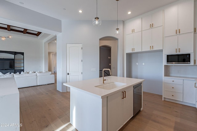 11328 E Dreyfus Ave, Scottsdale, AZ 85259 - kitchen with dishwasher, arched walkways, light wood-style flooring, white cabinetry, and tasteful backsplash