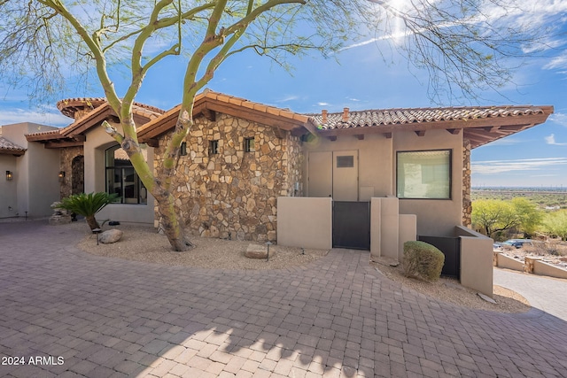 11328 E Dreyfus Ave, Scottsdale, AZ 85259 - mediterranean / spanish house featuring stucco siding, stone siding, and a tiled roof