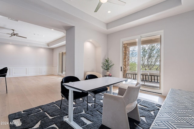 11328 E Dreyfus Ave, Scottsdale, AZ 85259 - dining room with a ceiling fan, a raised ceiling, a decorative wall, light wood-style flooring, and wainscoting