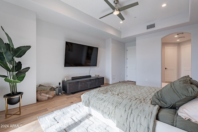 11328 E Dreyfus Ave, Scottsdale, AZ 85259 - bedroom featuring wood finished floors, recessed lighting, arched walkways, a raised ceiling, and a ceiling fan