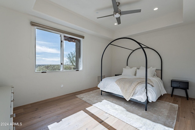 11328 E Dreyfus Ave, Scottsdale, AZ 85259 - bedroom with wood finished floors, a raised ceiling, recessed lighting, and ceiling fan