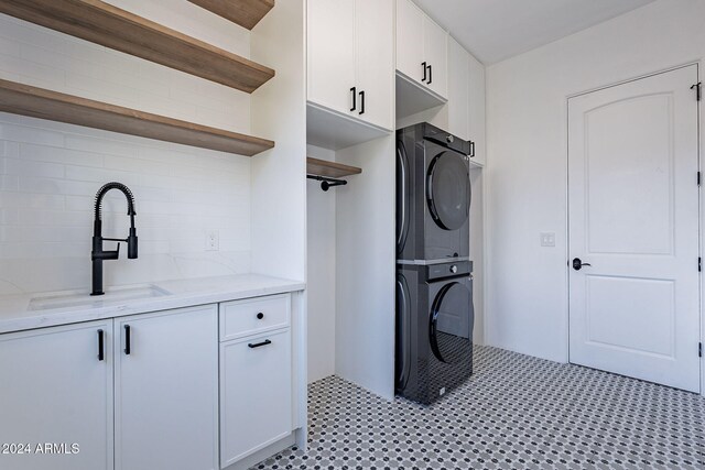 11328 E Dreyfus Ave, Scottsdale, AZ 85259 - washroom featuring stacked washer and clothes dryer and cabinet space