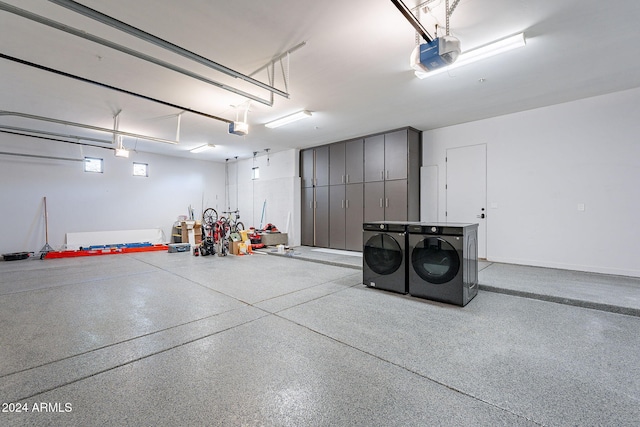 garage featuring separate washer and dryer and a garage door opener