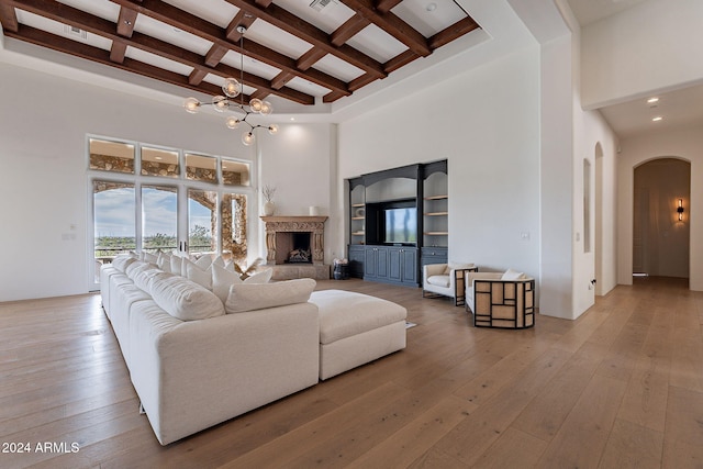 11328 E Dreyfus Ave, Scottsdale, AZ 85259 - living room with a high ceiling, arched walkways, beam ceiling, wood-type flooring, and coffered ceiling