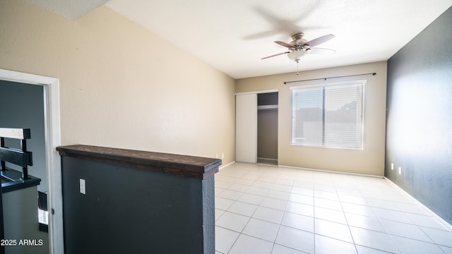 spare room featuring light tile patterned floors and ceiling fan