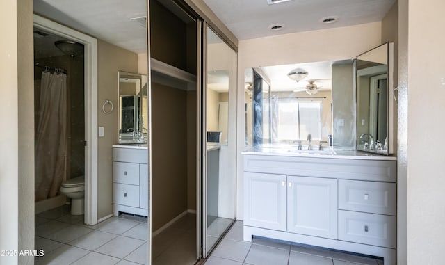 full bathroom featuring a ceiling fan, vanity, toilet, and tile patterned floors