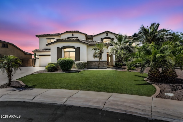 1755 E Tonto Dr, Chandler, AZ 85249 - mediterranean / spanish-style home with stucco siding, concrete driveway, a garage, a tiled roof, and stone siding