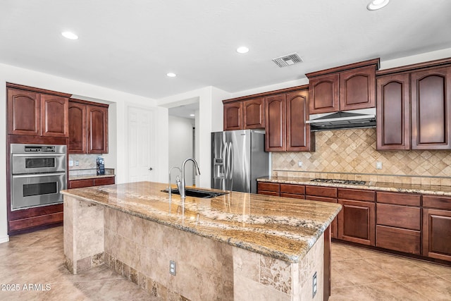 1755 E Tonto Dr, Chandler, AZ 85249 - kitchen with appliances with stainless steel finishes, under cabinet range hood, recessed lighting, light stone countertops, and tasteful backsplash