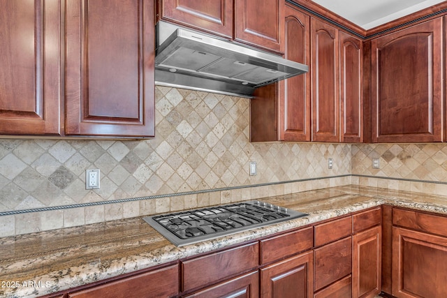 1755 E Tonto Dr, Chandler, AZ 85249 - kitchen with under cabinet range hood, stainless steel gas stovetop, light stone countertops, backsplash, and dark brown cabinets