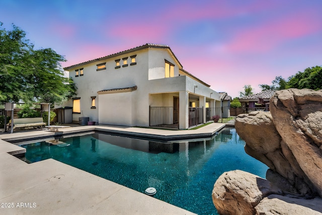 1755 E Tonto Dr, Chandler, AZ 85249 - pool at dusk featuring a patio and a diving board