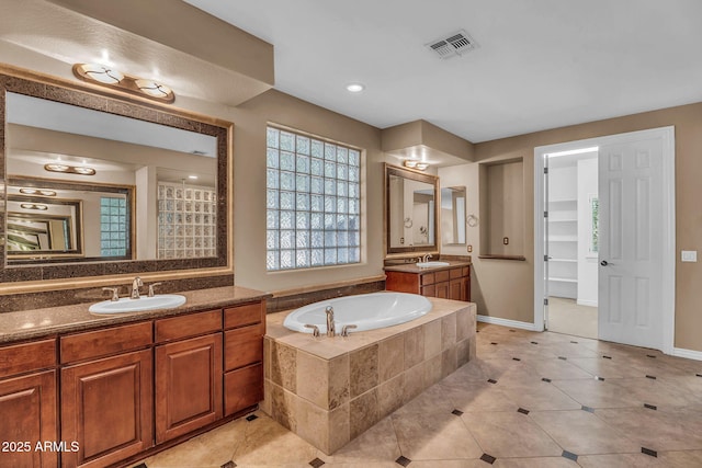 1755 E Tonto Dr, Chandler, AZ 85249 - bathroom featuring two vanities, a garden tub, and tile patterned floors