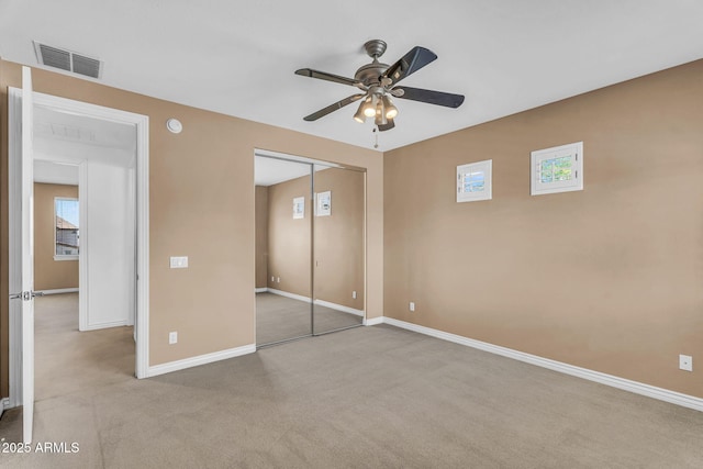 1755 E Tonto Dr, Chandler, AZ 85249 - unfurnished bedroom with carpet, a closet, multiple windows, and a ceiling fan