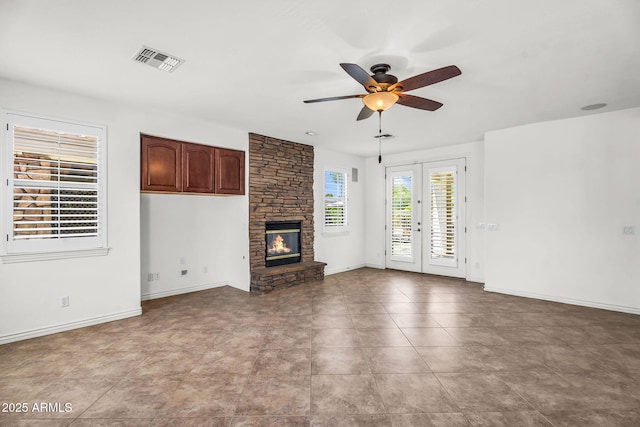 1755 E Tonto Dr, Chandler, AZ 85249 - unfurnished living room featuring ceiling fan and a stone fireplace