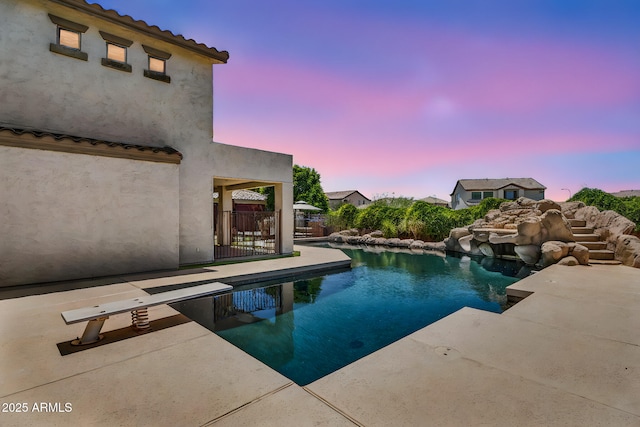1755 E Tonto Dr, Chandler, AZ 85249 - pool at dusk with a patio area and a diving board