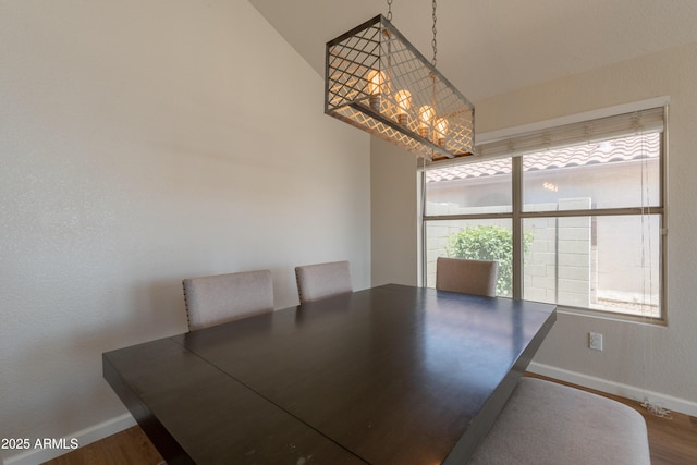 15128 W Melissa Ln, Surprise, AZ 85374 - unfurnished dining area with baseboards, wood finished floors, and a chandelier